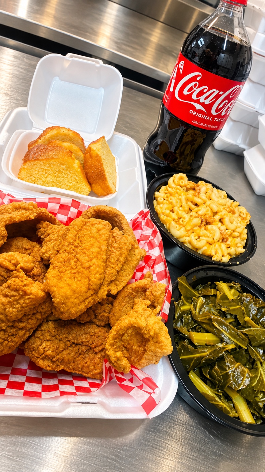 Fried chicken with macaroni and cheese, greens and cornbread